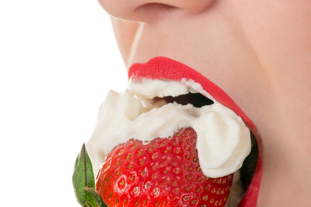 woman eating strawberry with cream, sensual red lips - Photo, Image