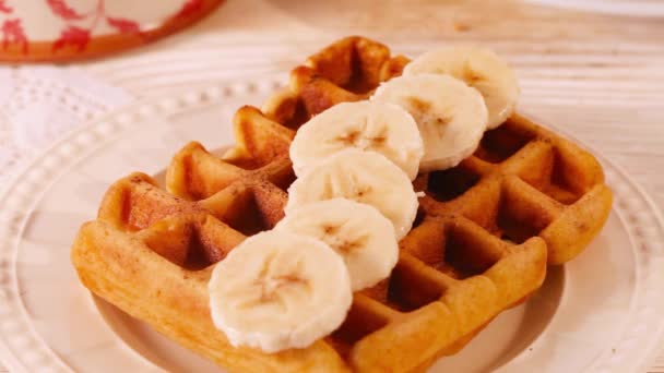 Belgian waffles with chocolate chips sprinkled arm, a broken tile, banana closeup - Кадры, видео