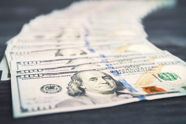 Dollar banknote row on dark wooden desktop - Photo, Image