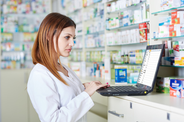 Pharmacist checking drugstore stock - Фото, изображение