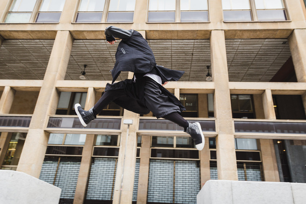 Stylish bearded man jumping in the street - Foto, Bild