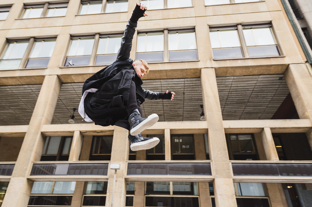 Stylish bearded man jumping in the street - Foto, Imagen