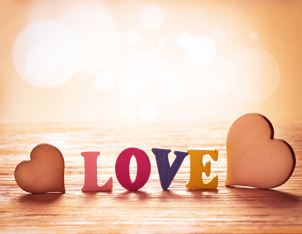 Hearts on wooden background with letters love - Photo, Image