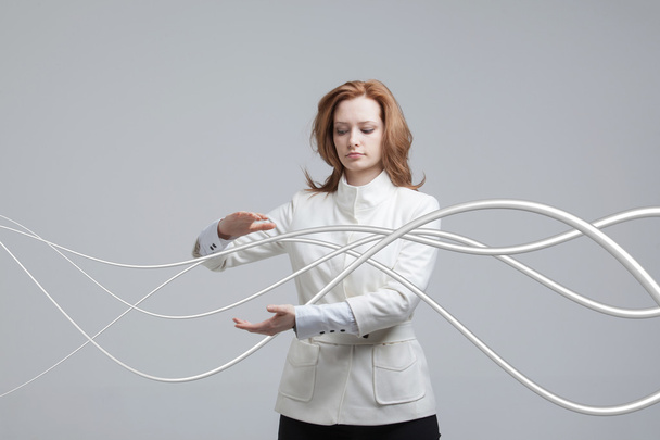 Woman with electrical cables or wires, curved lines - Photo, image