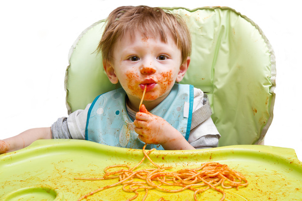 Little blond boy eating spaghetti  - Photo, image