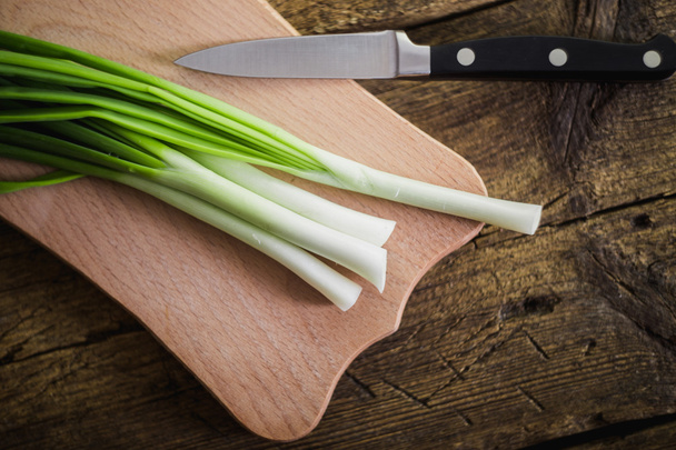 Green onions on wooden background. Cooking - Photo, Image