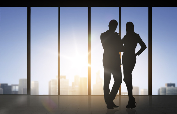 silhouettes of business partners over office - Valokuva, kuva