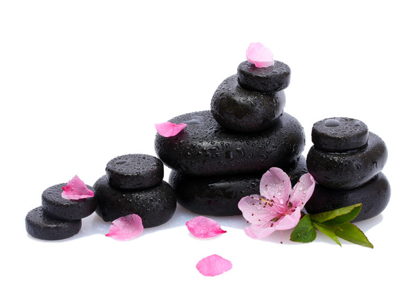Spa stones with drops and pink sakura flowers isolated on white - Fotografie, Obrázek
