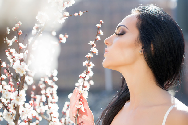 Woman with blooming apricot - Photo, image