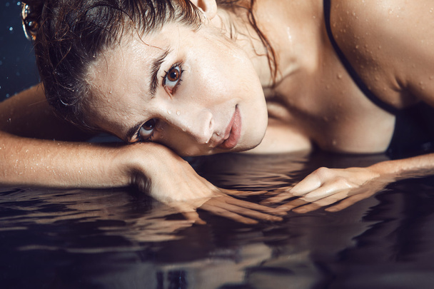 Close up of beautiful young woman lying in the water. - Foto, Imagem