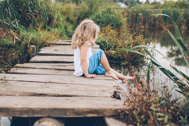girl on a wooden pier - Photo, Image