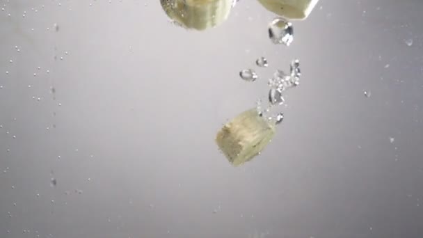 Pieces of banana drops under water. - Footage, Video