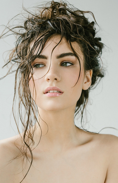Sexy brunette woman with wet hair beauty on grey - 写真・画像