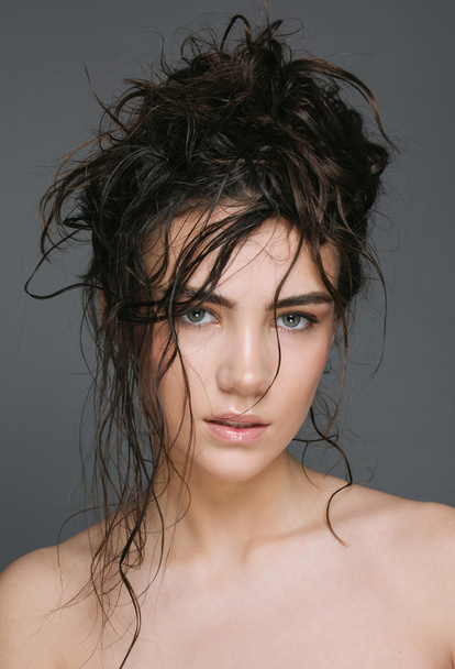 Sexy brunette woman with wet hair beauty on grey - Foto, Imagem