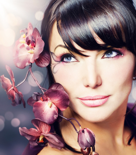 Beautiful Healthy Woman with Orchid flower - Photo, image