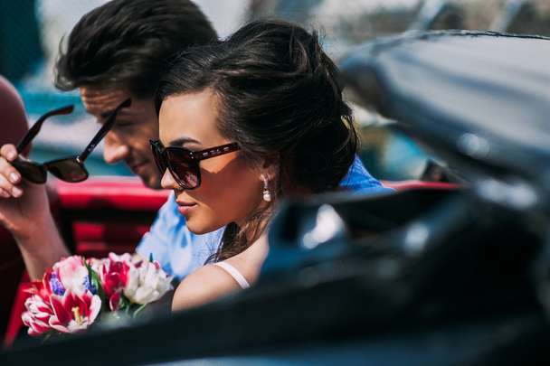 Young couple in vintage car - 写真・画像
