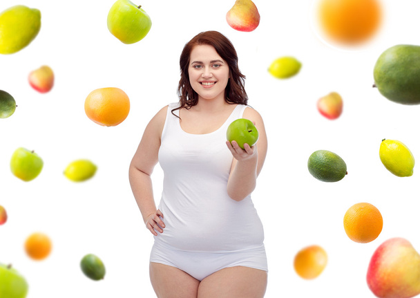 happy plus size woman in underwear with apple - Fotoğraf, Görsel