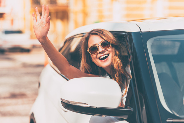 woman waving while sitting in car - Photo, Image