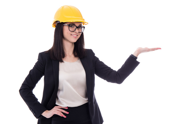 business woman architect in yellow helmet holding or presenting  - 写真・画像