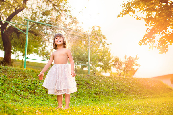 Chica en falda de princesa en el jardín
 - Foto, imagen