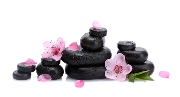 Spa stones with drops and pink sakura flowers isolated on white - Foto, Bild