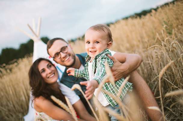 Young hipster father, mother cute baby son on picnic - Photo, image