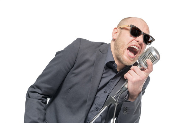 Unshaven bald man with microphone - Valokuva, kuva