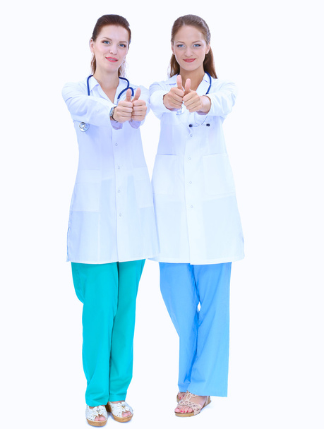 Two young woman doctor showing ok , standing in hospital - Fotoğraf, Görsel