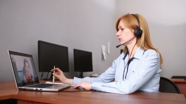 Female customer support operator. she leads online consultation using web camera - Footage, Video