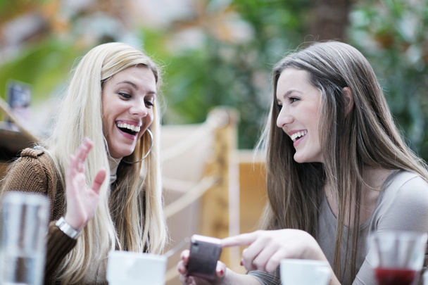 Cute smiling women drinking a coffee - Foto, Imagem