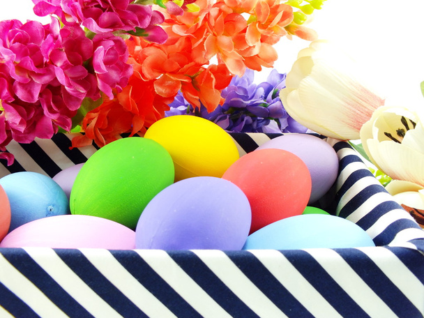 colorful easter eggs with spring flowers background  - Photo, image