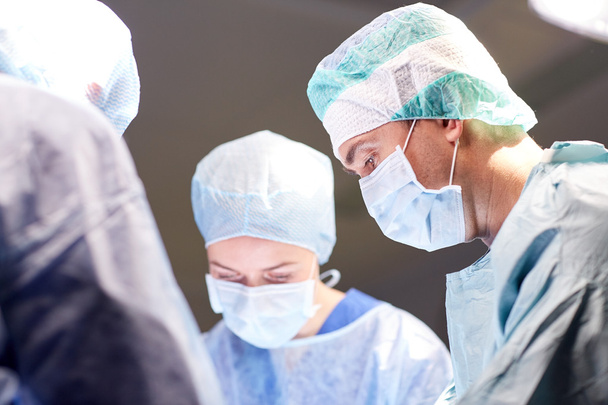 group of surgeons in operating room at hospital - Foto, immagini
