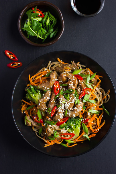 Bowl of soba noodles with beef and vegetables. Asian food. - Фото, изображение