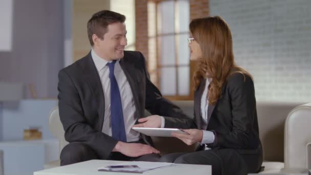 Sales manager and client joking, laughing after successful deal - Metraje, vídeo