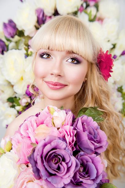  Young girl portrait in spring flowers - Photo, Image