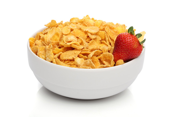 Pile of cornflakes on a bowl over white background - Photo, Image