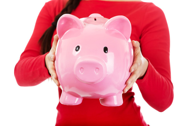 Young casual woman holding a piggybank - 写真・画像