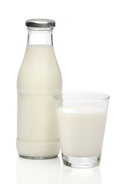 Milk bottle and a glass. With clipping path - 写真・画像