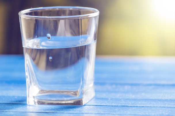 Water in  glass, on blue background - Fotoğraf, Görsel