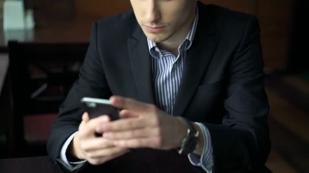 Handsome man touching  on the tablet at the table in cafe - Filmati, video