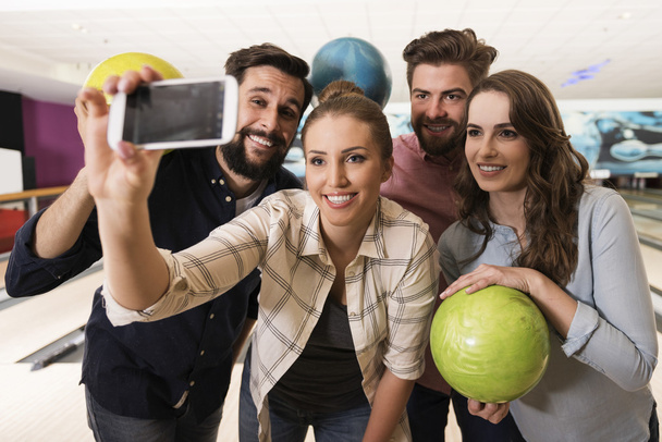 Friends taking selfie in bowling club    - Фото, зображення