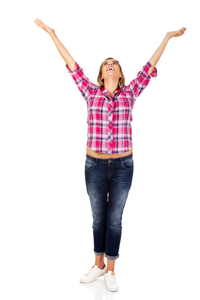 Happy blonde woman standing with hands up - Fotoğraf, Görsel
