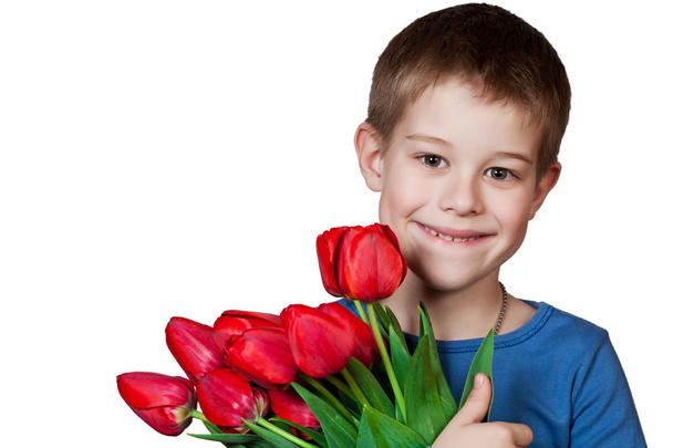 Young boy holding bouquet of tulips - Valokuva, kuva