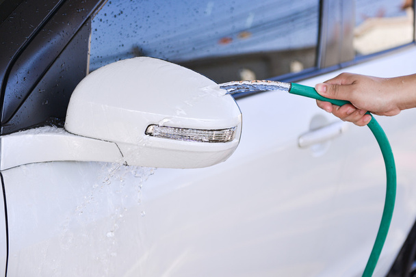 Washing a car with hose - Zdjęcie, obraz