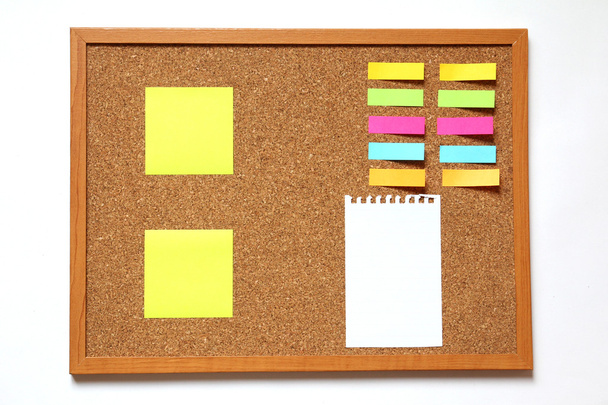 Cork board with note paper placed on white background - Fotografie, Obrázek