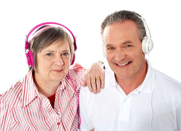 Cute senior couple listening to music together - Foto, afbeelding