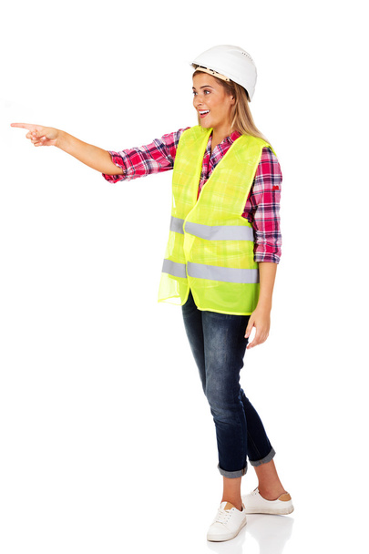 Smiling female builder in vest - Foto, Bild