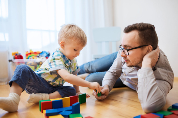 father and son playing with toy blocks at home - Фото, изображение