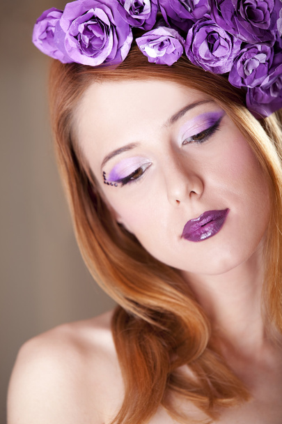 Portrait of beautiful redhead girl with style make-up and flower - Fotó, kép