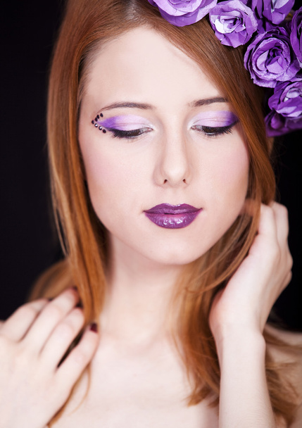 Portrait of beautiful redhead girl with style make-up and flower - Photo, Image
